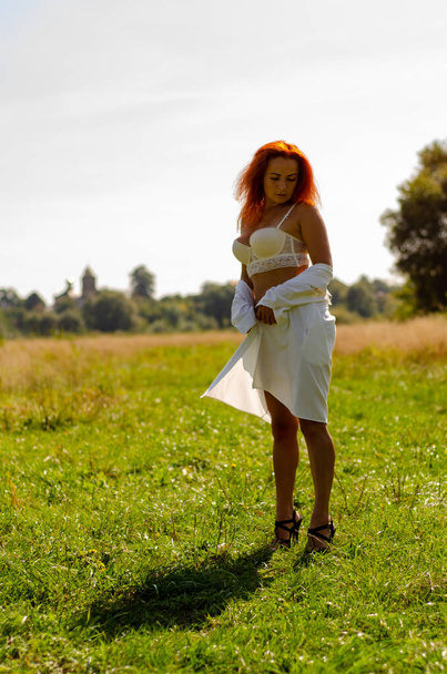 beautiful sexy woman in a white lingerie posing on green meadow - Фото, зображення