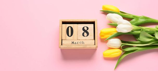 Calendar with date of International Women's Day and tulip flowers on color background - Photo, Image