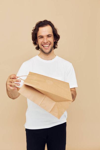 Attractive man paper bag emotions posing Lifestyle unaltered - Foto, Bild