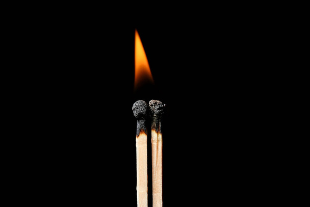 Burning matches on black background. Concept of relationship burnout - Photo, Image