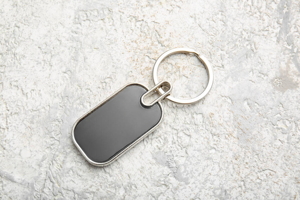 Stylish metallic keychain on light background - Photo, Image