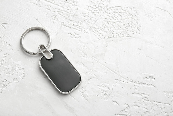Stylish metalLic keychain on light background - Photo, Image