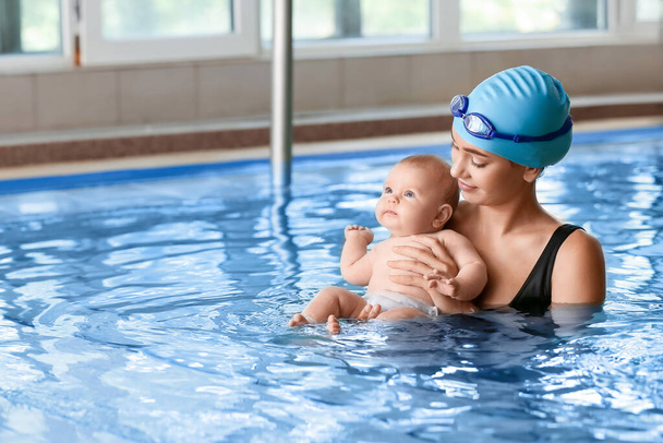 Coche de natación y lindo bebé en la piscina - Foto, Imagen