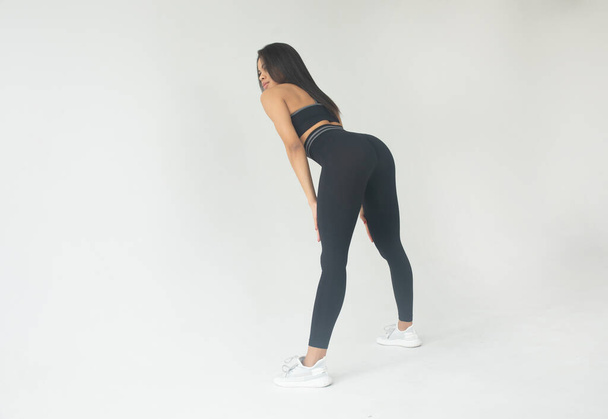 attractive young fit african american woman in black sportswear posing in studio   - Zdjęcie, obraz