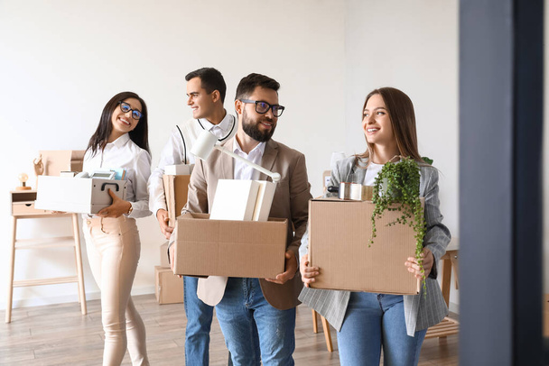 Business people holding boxes with things in office on moving day - Photo, Image