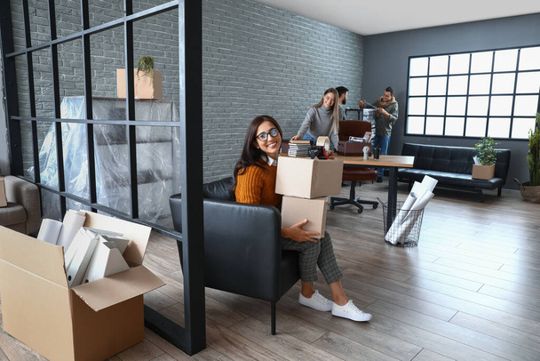 Businesswoman with boxes in office on moving day - Photo, Image