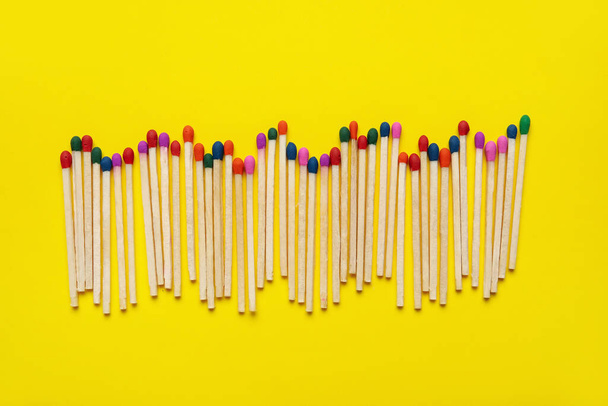 Different new matchsticks on yellow background - Photo, Image
