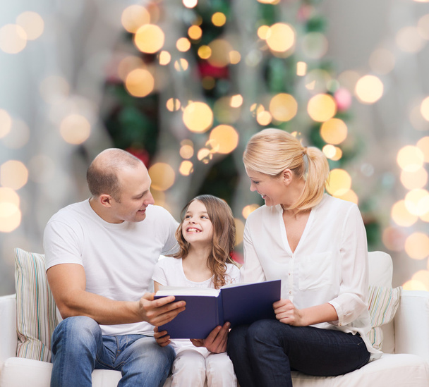 happy family with book at home - Foto, Imagem