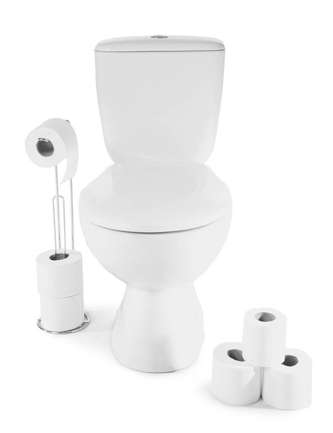 Holder with rolls of soft paper and toilet bowl on white background - Foto, imagen