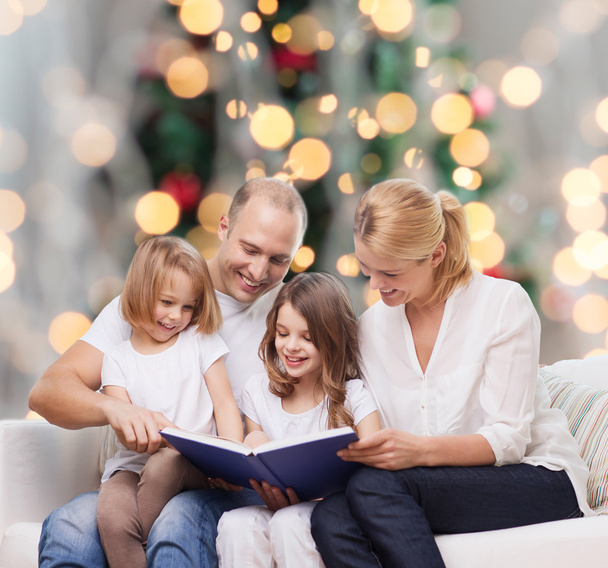 happy family with book at home - Фото, изображение