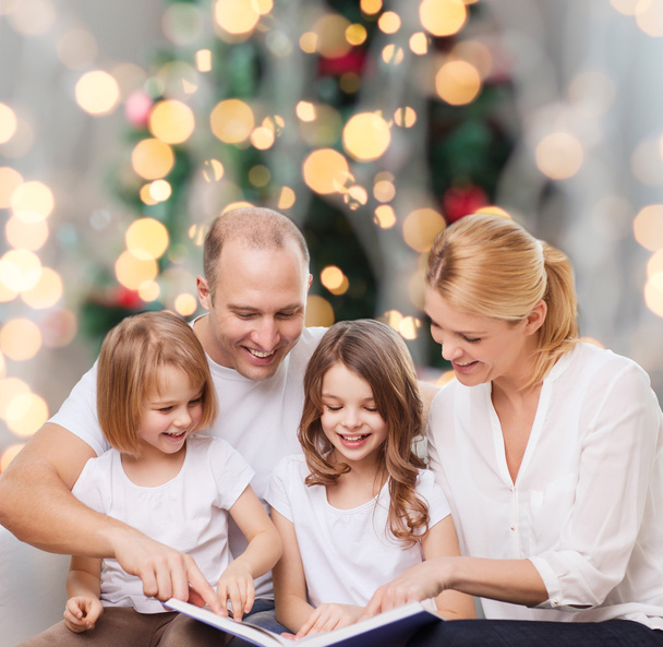 happy family with book at home - Foto, Bild