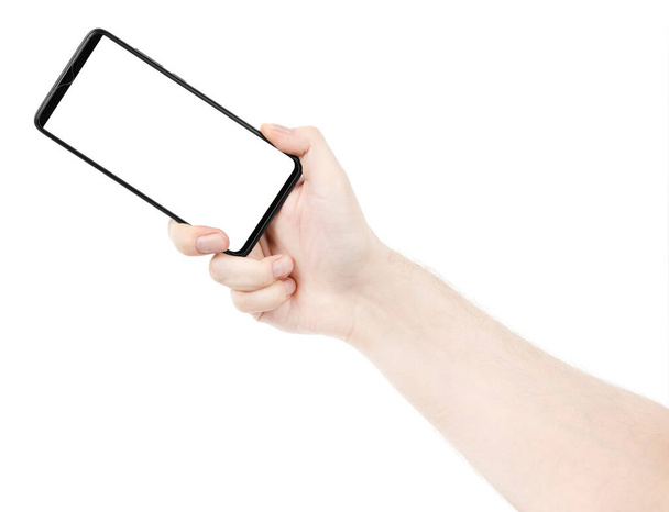 Male hand holding the black new smartphone with blank screen isolated white background. Man hands using phone clipping path. blank for designer - Φωτογραφία, εικόνα