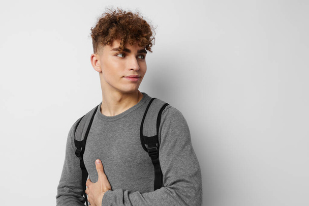 stylish guy in a gray sweater backpack fashion isolated background - Foto, Imagem