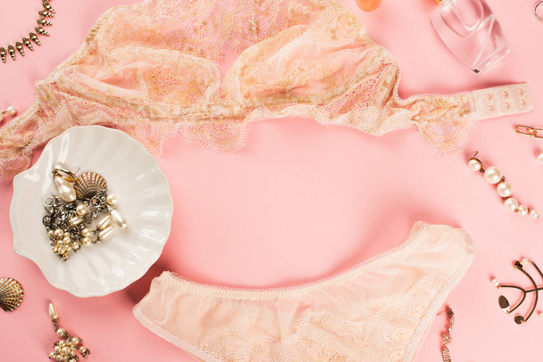 Top view of lace lingerie, perfume and accessories on pink background  - Fotoğraf, Görsel