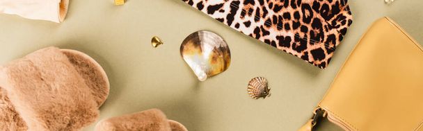 Top view of slippers, bag and bra with leopard print on green background, banner  - Photo, Image