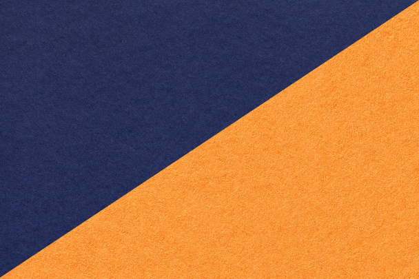 Texture of navy blue and orange paper background, half two colors, macro. Structure of dense indigo kraft cardboard. Felt backdrop closeup. - Zdjęcie, obraz
