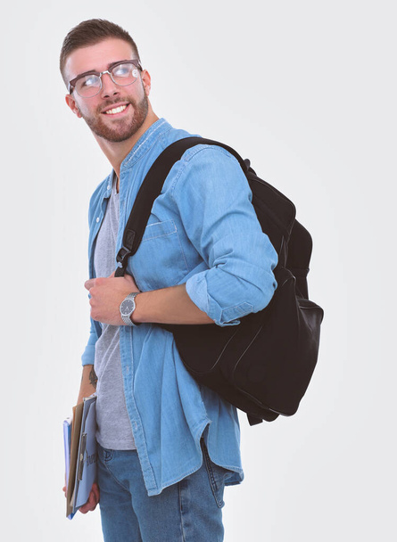 A male student with a school bag holding books isolated on white background. Education opportunities. College student. - Foto, imagen