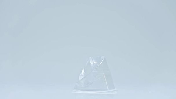 crumbled plastic cup on grey background with copy space, environmental concept - Photo, Image