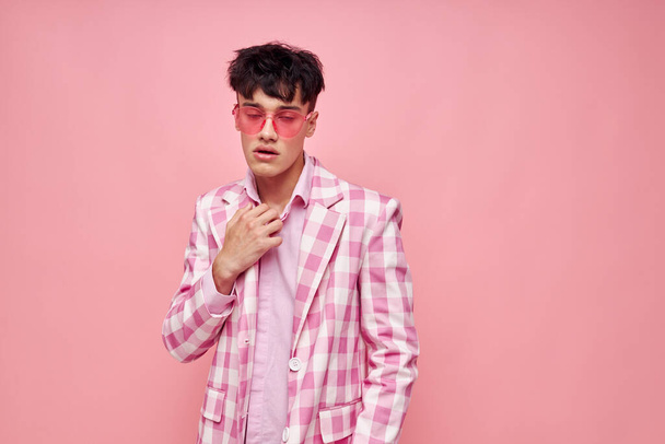 pretty man fashionable pink sunglasses jacket posing isolated background unaltered - Φωτογραφία, εικόνα