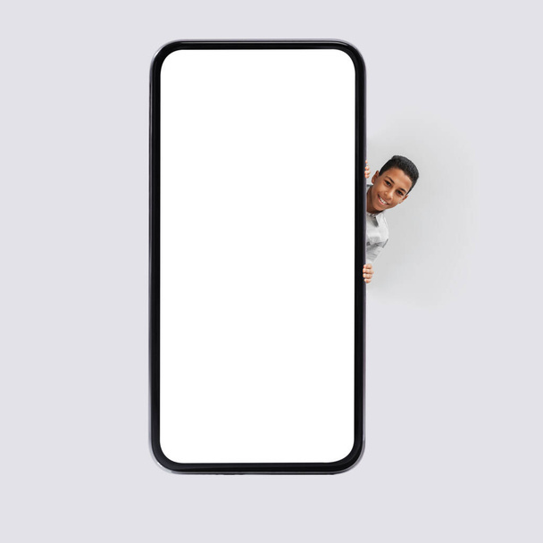 Black Boy Posing Near Big Smartphone Blank Screen - Фото, зображення