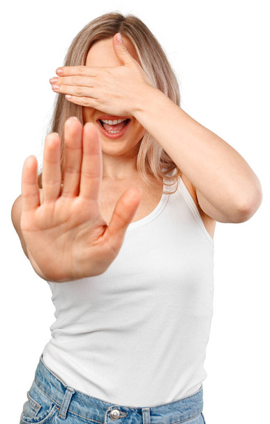 Young beautiful blonde woman covering eyes with hands and doing stop gesture isolated on white - 写真・画像