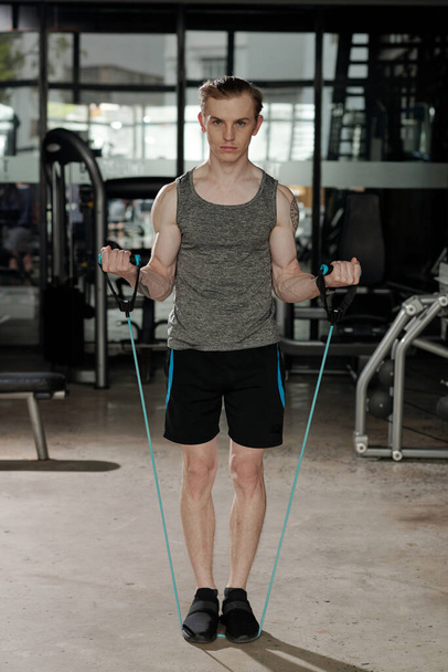 Man Exercising with Resistance Band - Photo, Image