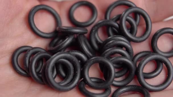 Rubber gaskets for plumbing seals in hand close-up. Sealing rings. Hydraulic repair spare - Footage, Video
