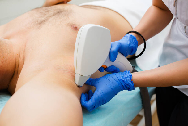 High Angle View Of A Therapist Giving Laser Epilation Treatment On Man's Armpit - Fotoğraf, Görsel