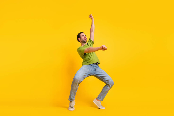 Full size profile side photo of young man have fun ride horse look empty space isolated over yellow color background. - Fotoğraf, Görsel