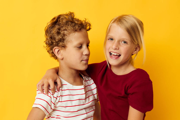 two joyful children standing side by side posing childhood emotions isolated background - Φωτογραφία, εικόνα