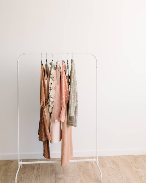 Rack with capsule clothes in beige and pink colors - Zdjęcie, obraz