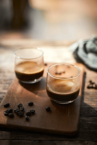 Close up of two espresso in shot glasses.  - 写真・画像