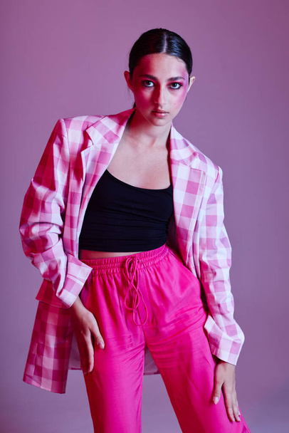 pretty woman pink pants fashion clothing posing isolated background unaltered - Valokuva, kuva