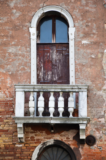 Window with balcony at an old decayed house in Venice, Italy - Photo, image