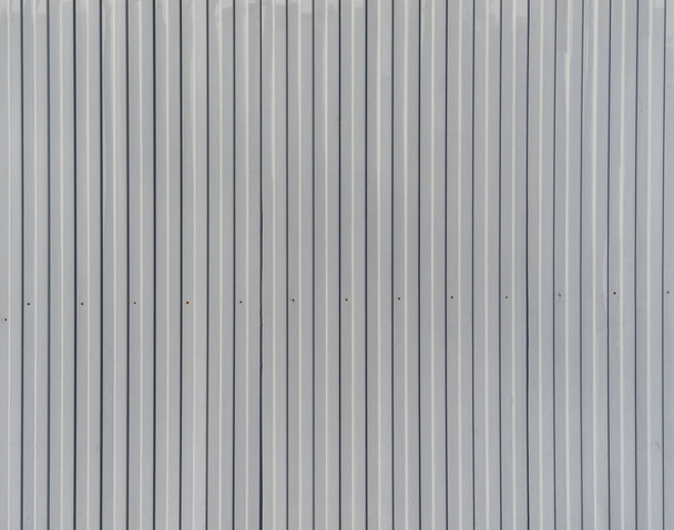 Corrugated iron. Texture fragment. Gray metal. extruded surface - Φωτογραφία, εικόνα