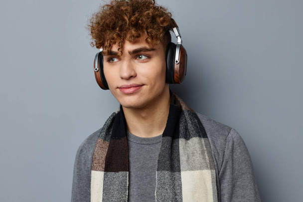 stylish guy elegant style checkered scarf headphones light background - Foto, Imagem