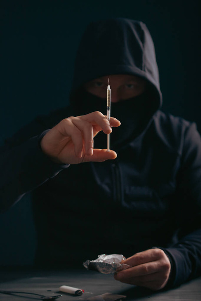 Addict/junkie man preparing drugs. The concept of crime and drug addiction. - Valokuva, kuva