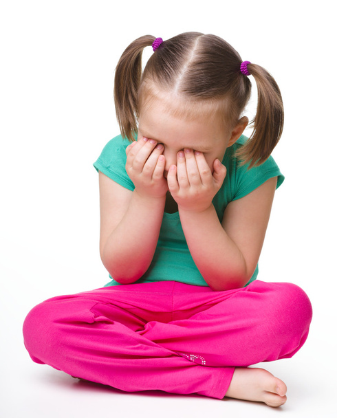 Little girl is sitting on floor and crying - Photo, Image