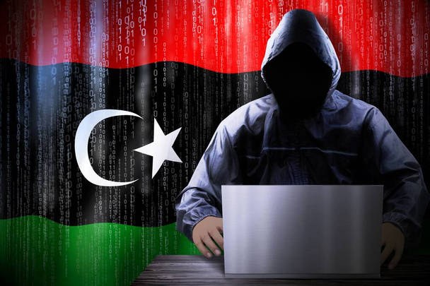 Anónimo hacker encapuchado, bandera de Libia, código binario - concepto de ataque cibernético - Foto, Imagen