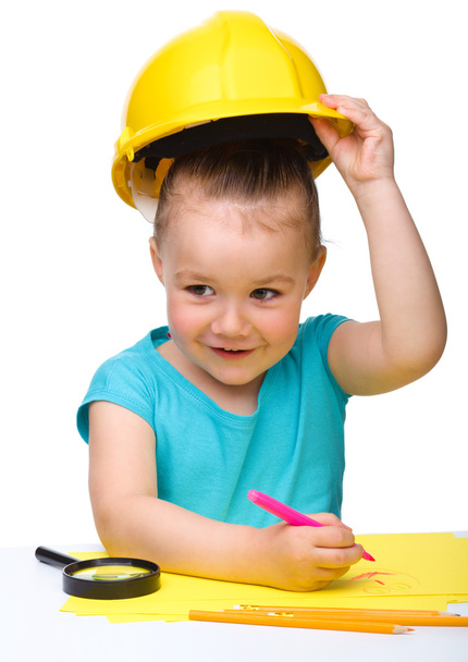 Cute little girl draw with marker wearing hard hat - Photo, Image