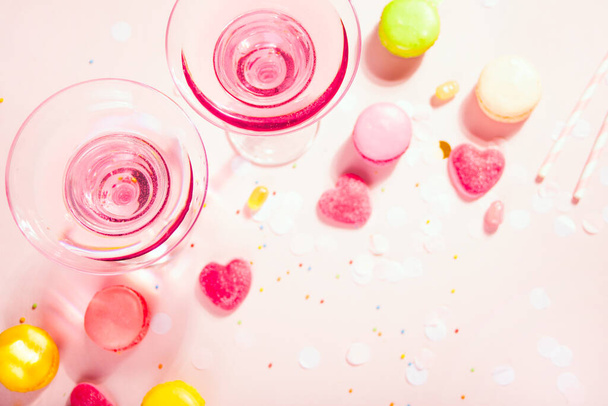 Glasses of pink cocktails with heart candies and macaroons. Birthday party or Valentines day concept. Copy space. - Fotografie, Obrázek