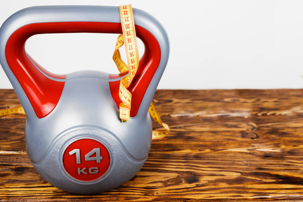 a sports kettlebell on a wooden background. Healthy lifestyle. - Photo, Image
