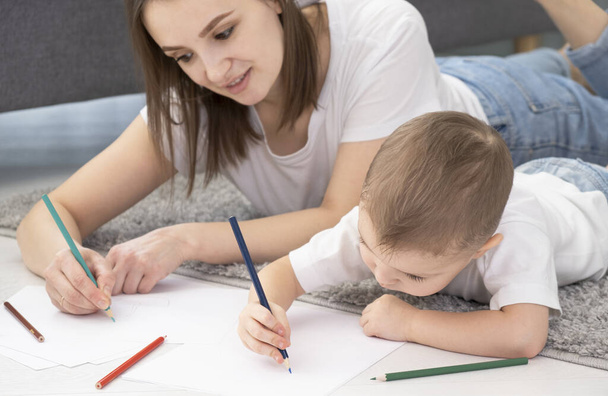Happy little child boy hand drawing pictures with mom. - Fotoğraf, Görsel