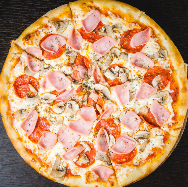 italian pizza on the dark background - Фото, изображение