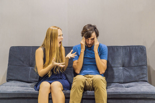 Young couple swears on the couch. Emotional intelligence concept - 写真・画像
