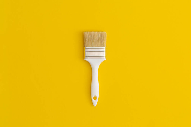 Paint brush on yellow background. - Photo, Image