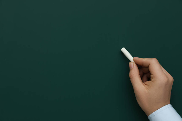 Man with white chalk near green board, closeup. Space for text - Foto, Imagem
