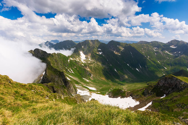 landscape of fagaras mountains in summer. beautiful nature scenery of romania. steep hills, grassy meadows and rocky peaks on a sunny day. popular travel destination - Фото, зображення
