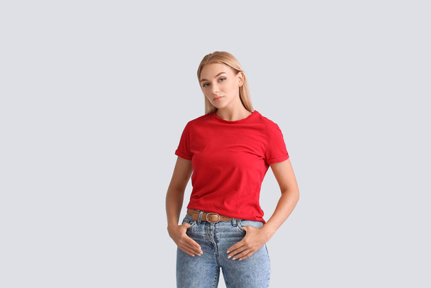 Mujer joven de moda en jeans con estilo sobre fondo claro - Foto, imagen