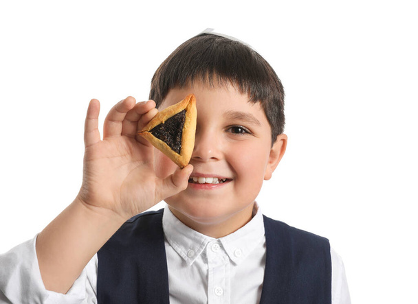 Little Jewish boy with tasty Hamantaschen for Purim holiday on white background - Photo, Image